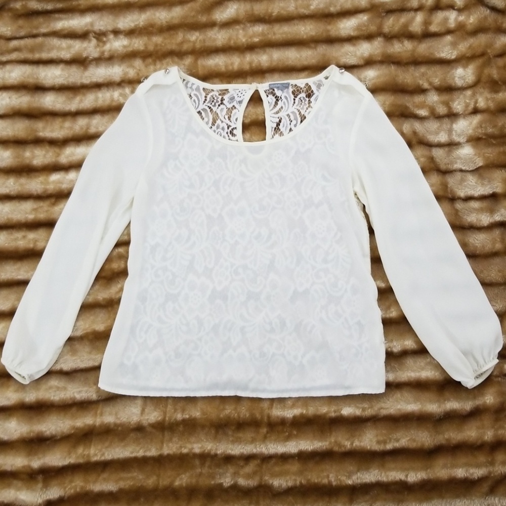 An ivory, long sleeved blouse